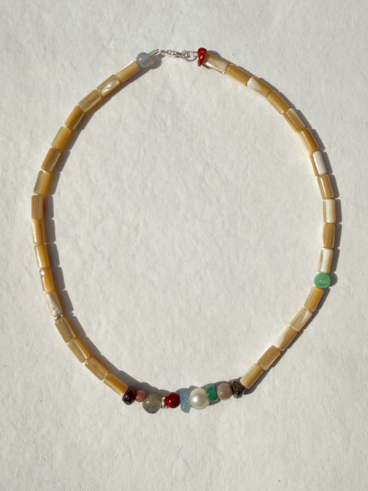 the collector necklace in sand