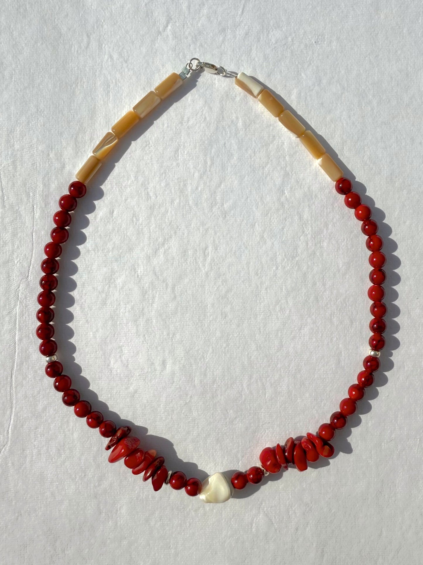 necklace made of red coral and mother of pearl with shell detail and sterling closures. 